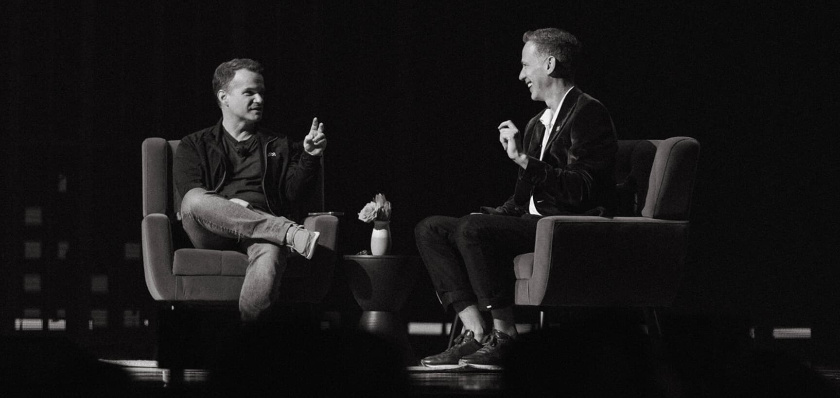 Tristan and George speaking on stage.