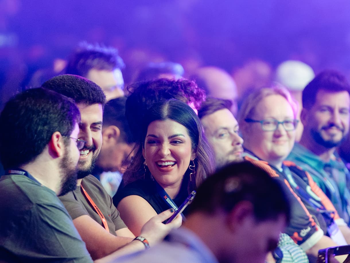 Attendees laughing together in the dbt Summit 2026 keynote audience