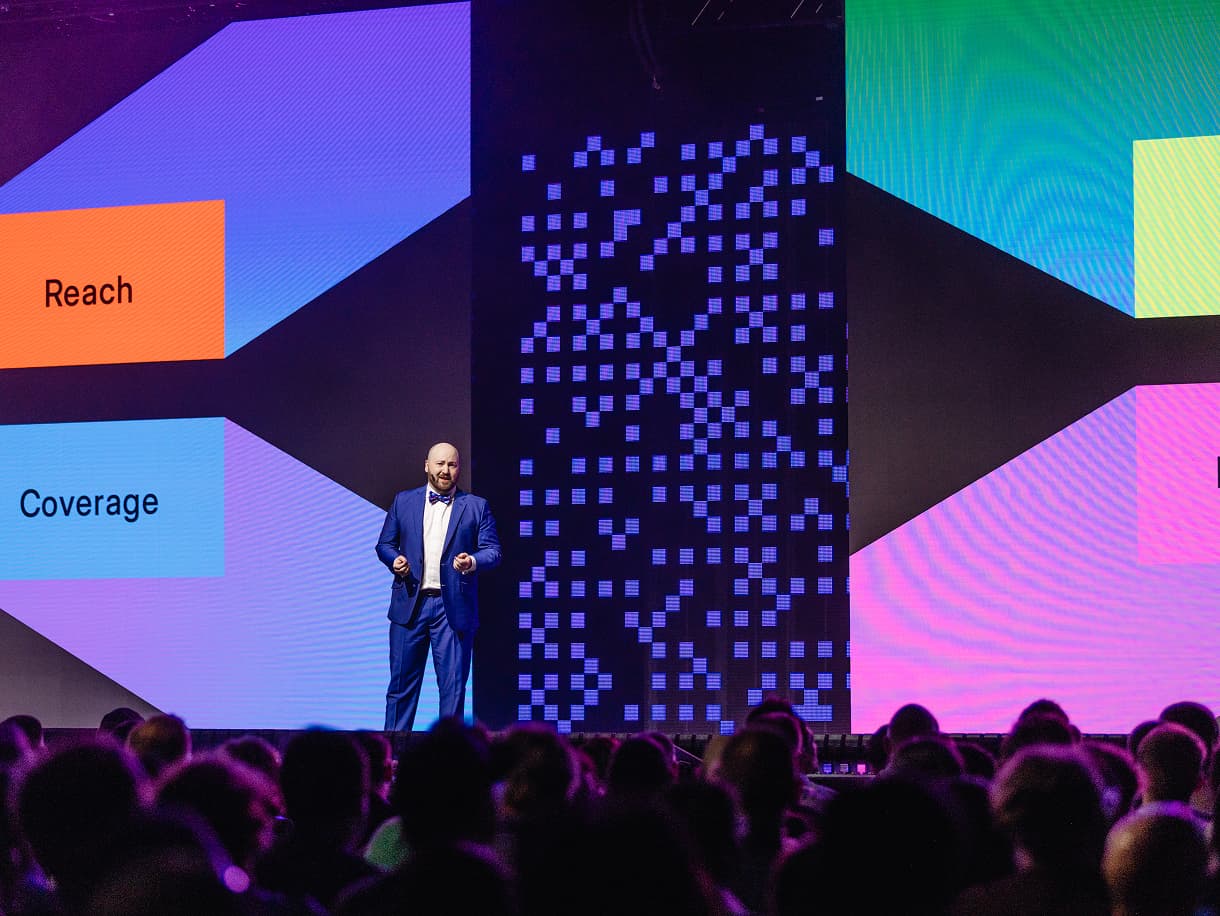 A speaker presenting on the dbt Summit 2026 main stage
